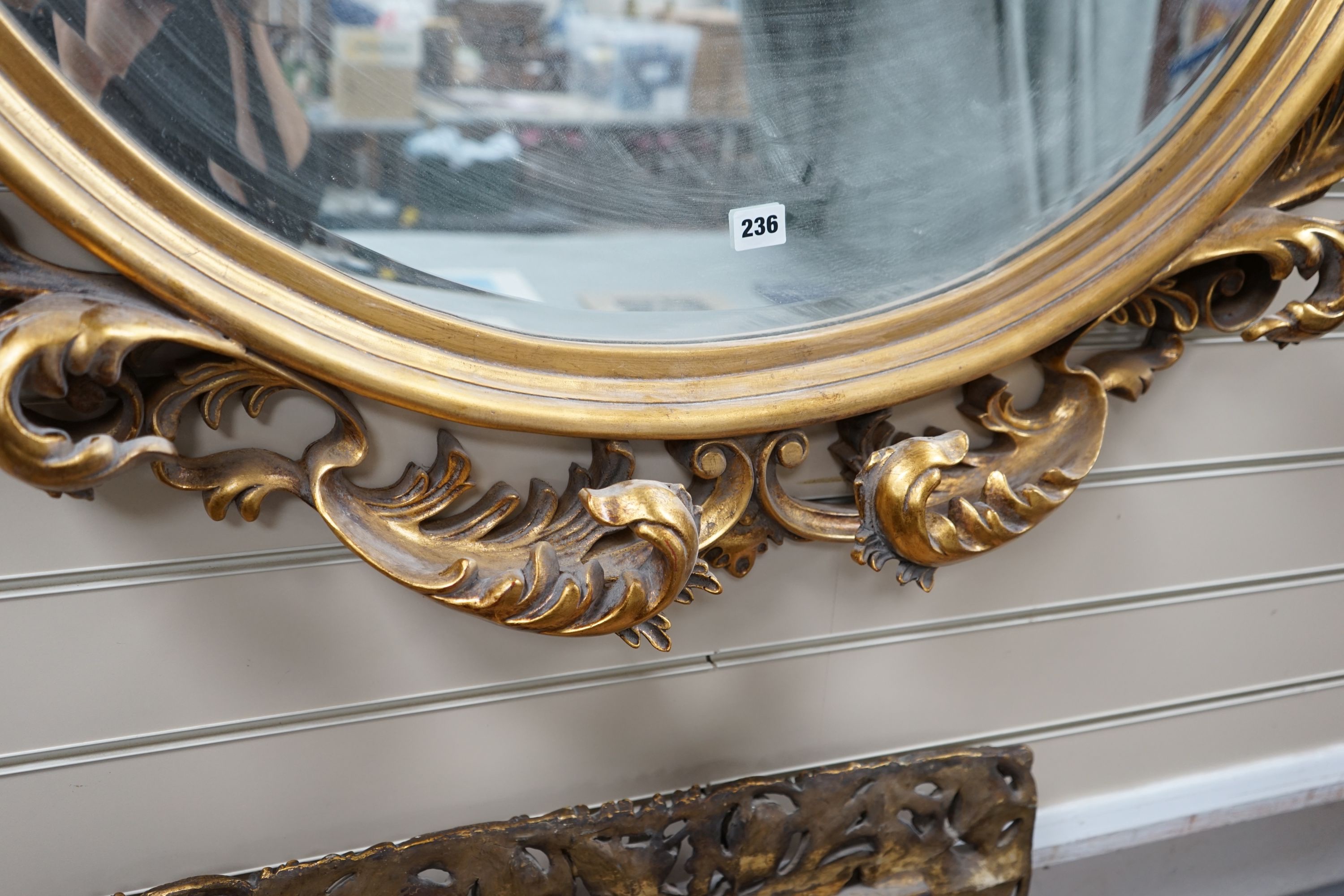 A large moulded gilt frame oval mirror, width 112cm height 110cm